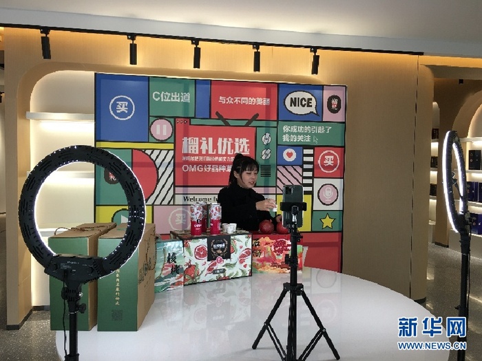 （工作人员正在为石榴、石榴饮品等产品进行直播带货。 新华网 于杨 摄）